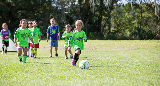 youth soccer programs, 3v3, 3v3 tournaments, Image of Girl Dribbling Ball at a Tampa Youth Soccer Program Class